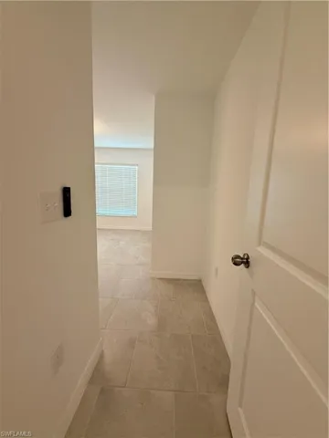 Corridor featuring baseboards