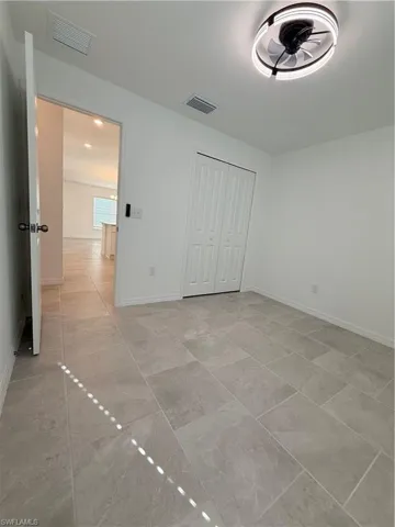 Unfurnished bedroom with a closet and baseboards