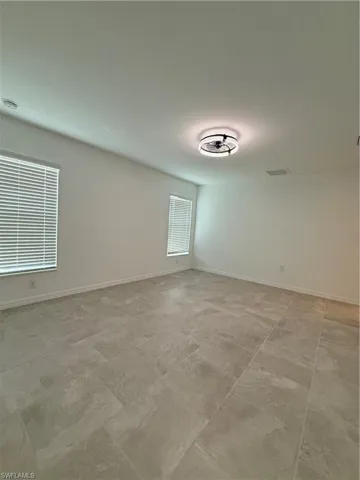 Unfurnished room featuring healthy amount of natural light