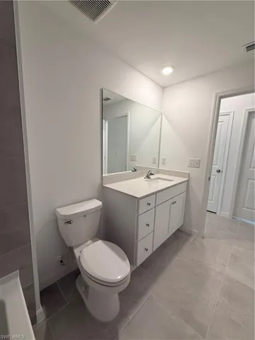 Bathroom featuring vanity and baseboards