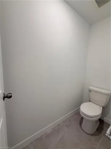 Bathroom featuring toilet and tile patterned flooring