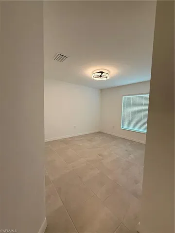 Empty room featuring baseboards