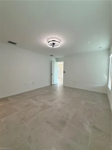 Unfurnished room with baseboards