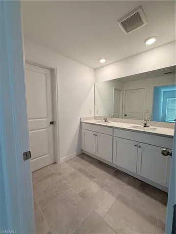 Bathroom featuring double vanity and recessed lighting