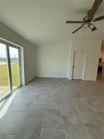 Spare room with ceiling fan and a water view