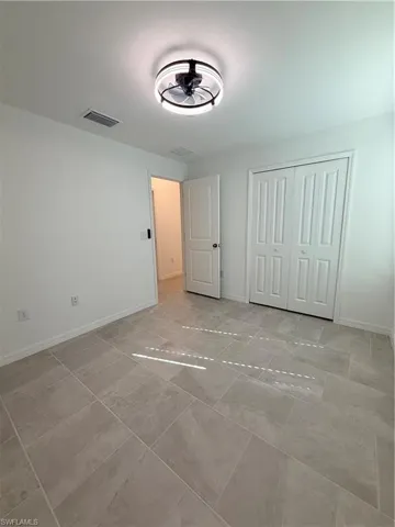 Unfurnished bedroom featuring a closet and baseboards