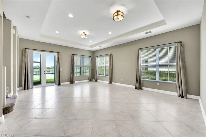 Unfurnished living room with a tray ceiling