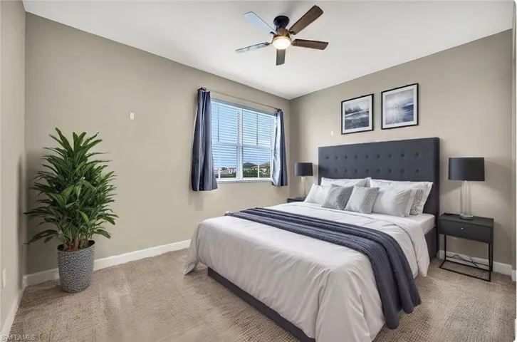 Staged bedroom featuring ceiling fan
