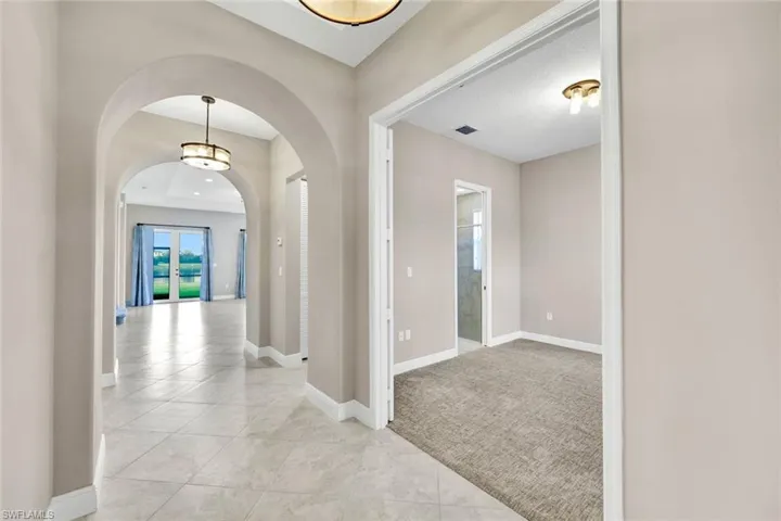 Unfurnished room with a tray ceiling and french doors