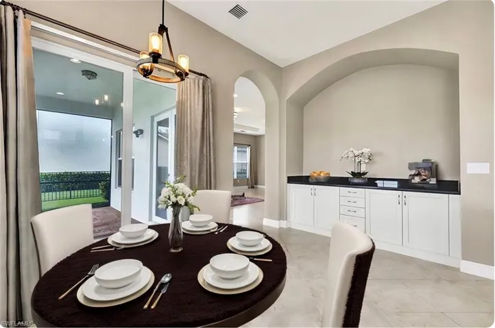 Staged breakfast area featuring a lake view