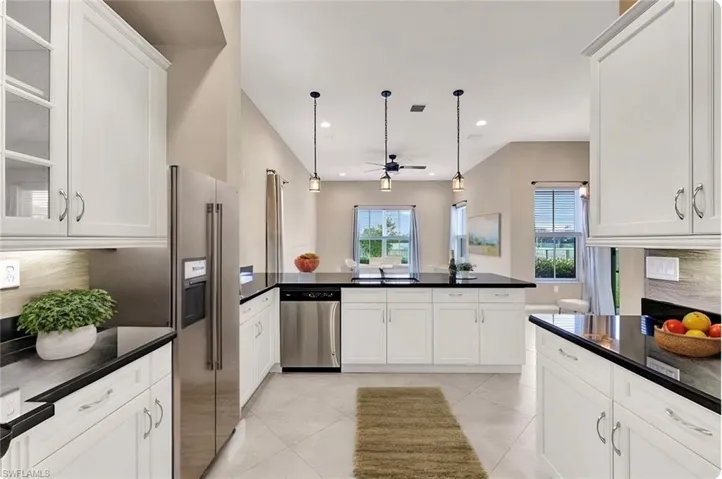 Staged kitchen area featuring a raised ceiling