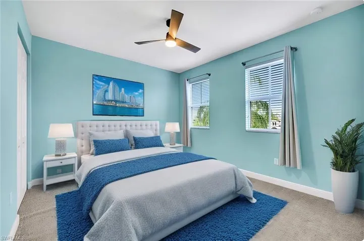 Staged upstairs Bedroom with light carpet, a closet, and ceiling fan