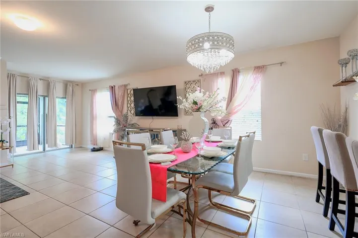 Bright dining area featuring a decorative chandelier and tile flooring