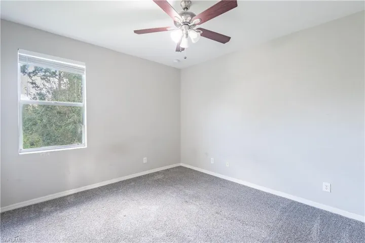 Bedroom 5 with carpet floors and ceiling fan