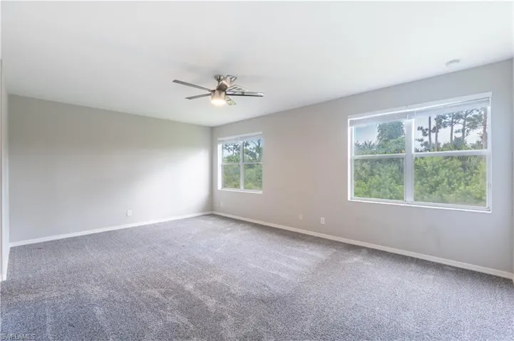 Master bedroom with carpet floors and ceiling fan