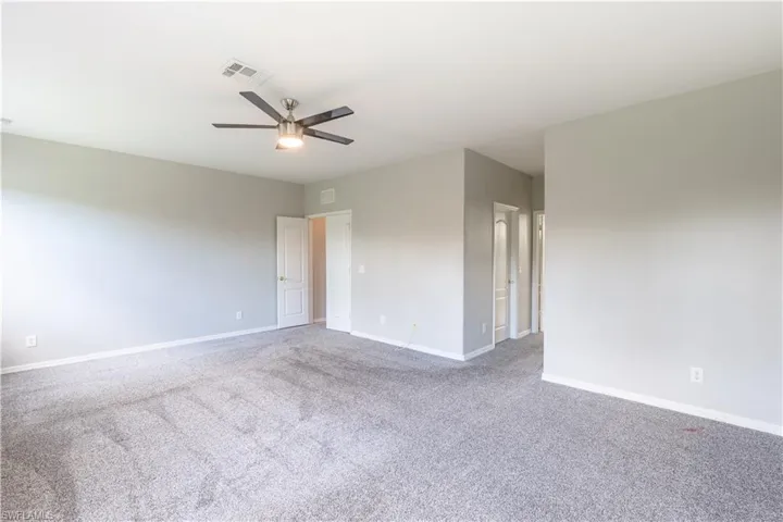 Master bedroom with carpet and ceiling fan