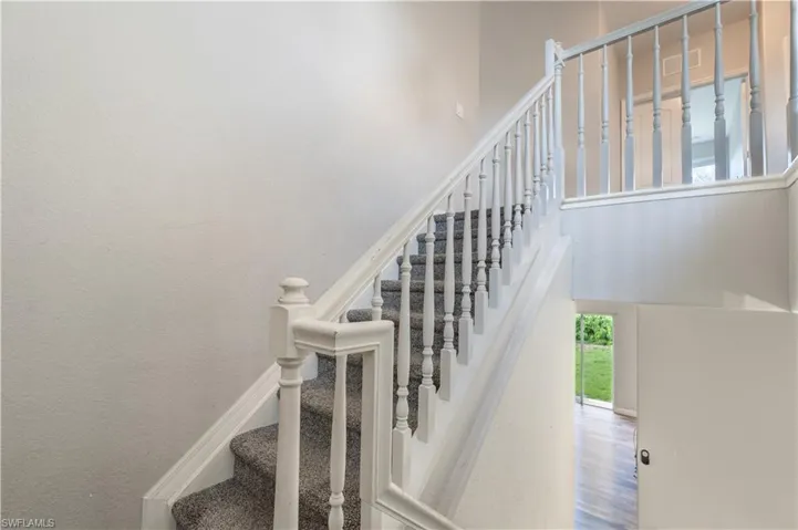 Stairway featuring carpet floors