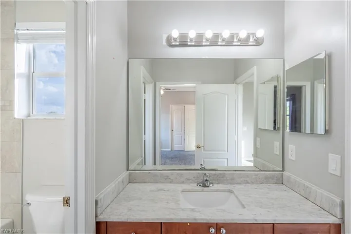 Jack and Jill bathroom 1 featuring vanity and toilet