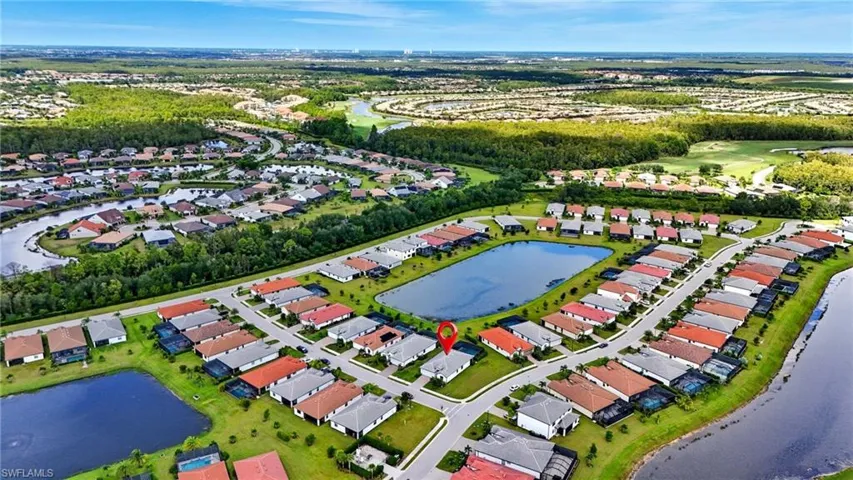 Aerial view of property and surrounding area with nearby suburban area