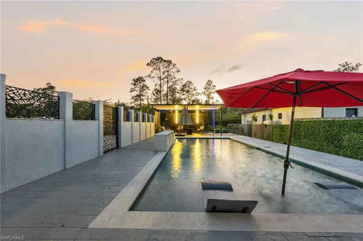 Rectangular swimming pool featuring submerged lounging platforms and underwater lighting