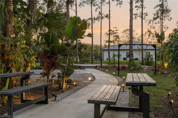 Outdoor concrete pathway surrounded by gravel and accent lighting