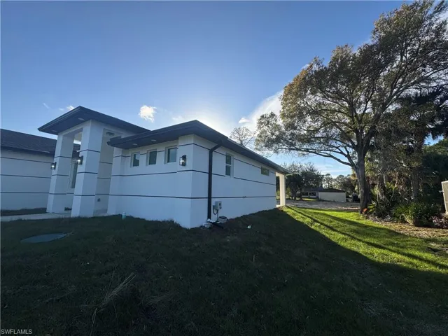 View of property exterior featuring a yard