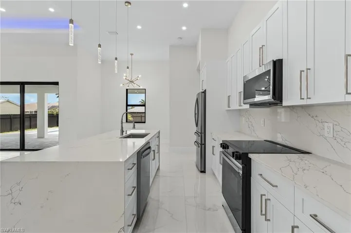 Kitchen featuring appliances with stainless steel finishes, plenty of natural light, recessed lighting, and a sink