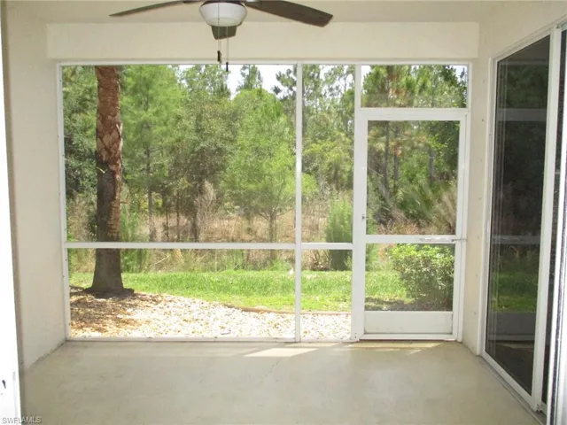 Unfurnished sunroom with ceiling fan