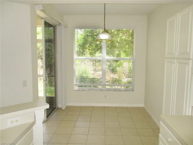 Unfurnished dining area with light tile floors