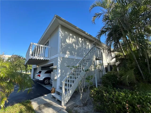View of home's exterior featuring a balcony and a carport