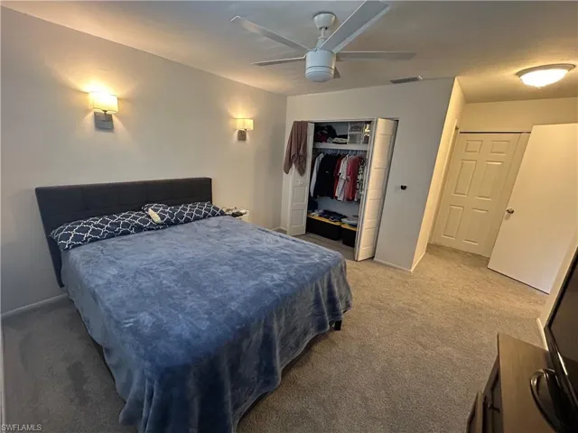Bedroom featuring carpet floors, a closet, and ceiling fan