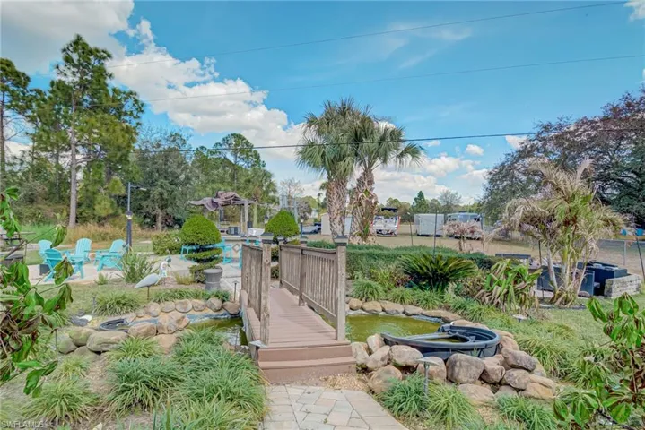 View of yard with a garden pond and a swimming pool