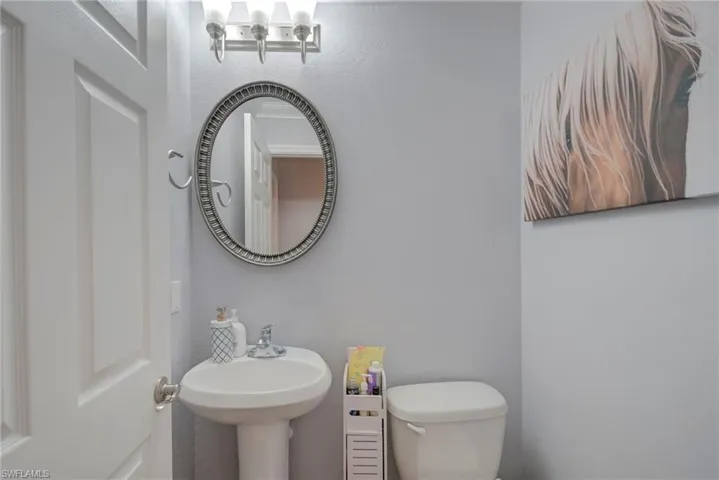 Half bath with toilet and a textured wall