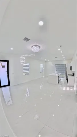 Unfurnished room with recessed lighting, light tile patterned floors, and a chandelier