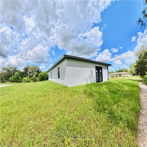 View of home's exterior with a lawn and stucco siding