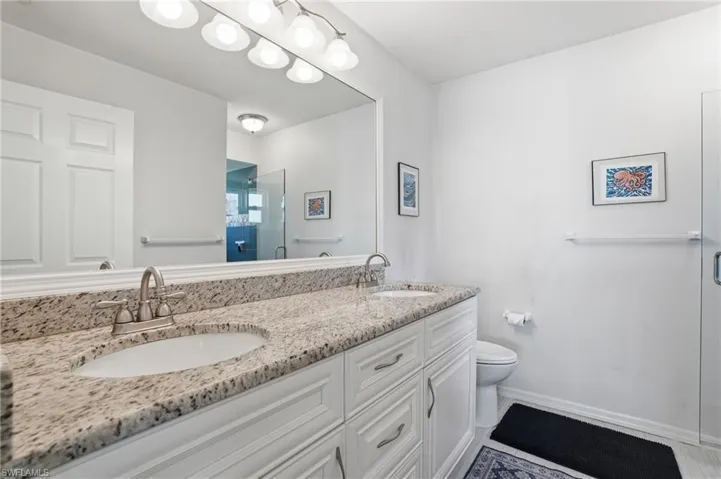 Full bath with a glass shower and double vanity