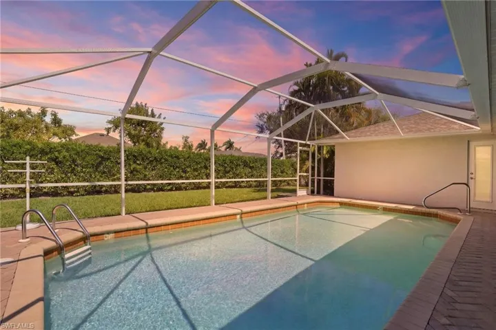 Outdoor pool featuring a patio area and screen enclosure