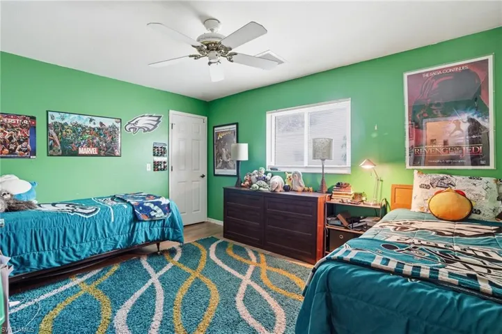 Bedroom with a ceiling fan and wood tile floors