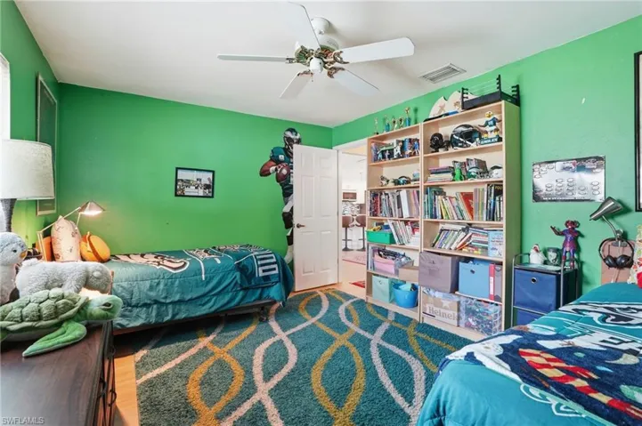 Bedroom with a ceiling fan and wood tile floors