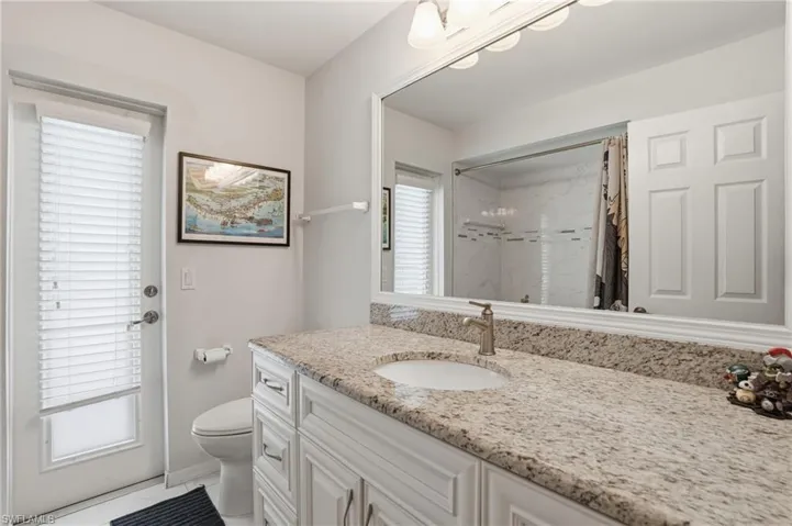 Pool Bathroom featuring vanity, a tile shower and tub, and light tile patterned floors