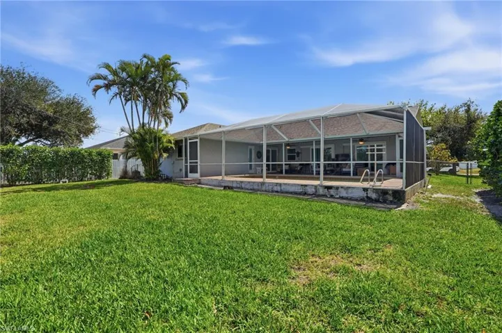 Back of house with a patio area, screen enclosure, and an outdoor pool