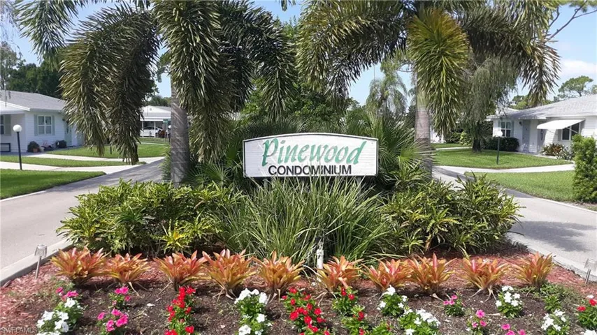Community / neighborhood sign with a yard
