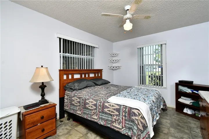 Bedroom featuring a textured ceiling and a ceiling fan