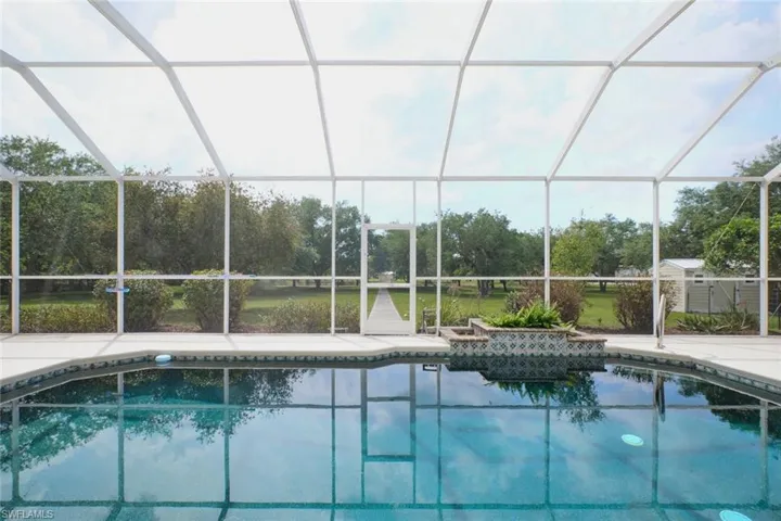 Look at your pool/yard.  One shed to the far right.  Concrete walkway to the lake.  Beautiful shade trees.  This is a very unique and beautiful property you won't want to miss seeing!  SPACE - look at all the space to call home!