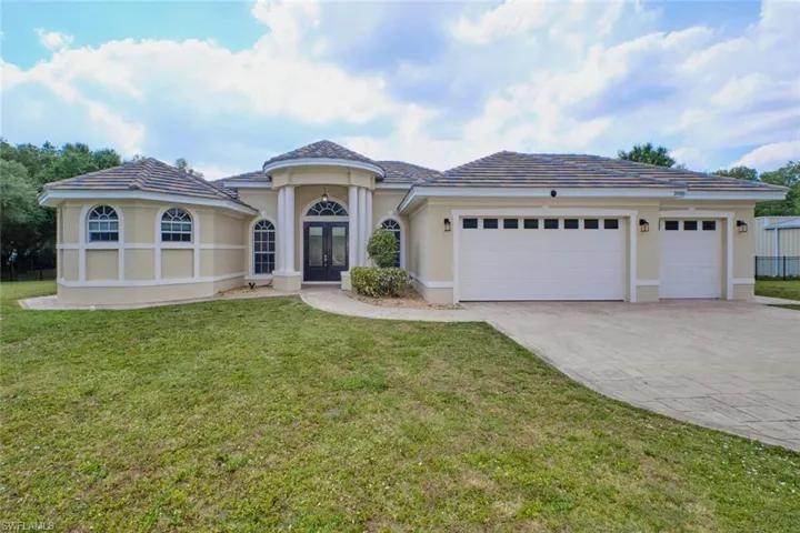 Front view of home.  Tile roof and tiled throughout.  Split bedrooms.  Currently the smaller section of the garage has been turned into an air-conditioned office, pantry, playroom, man/woman cave - whatever you want it to be OR it can be removed easily.