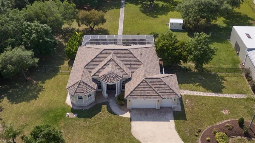 Surrounded by MANY beautiful Oak Trees, property is nearly 100% fenced, dog yard, chicken coop (can stay if you like).  Very nice walk-way through the property.