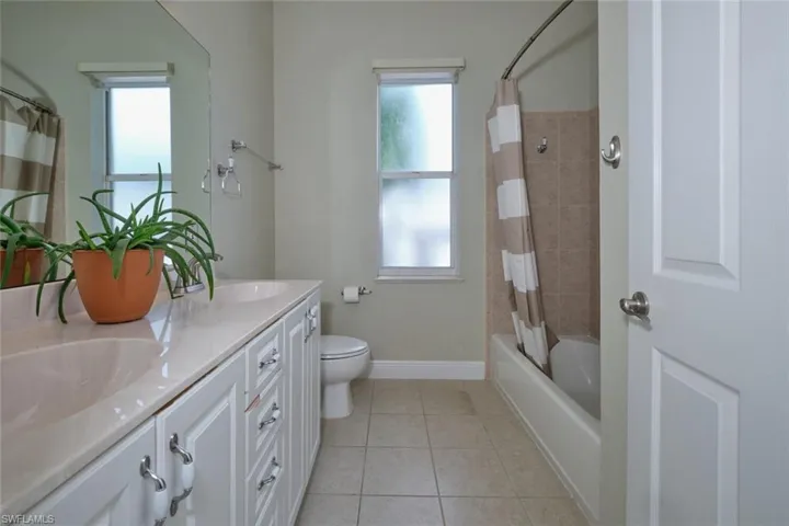 Guest bathroom with linen closet behind door.