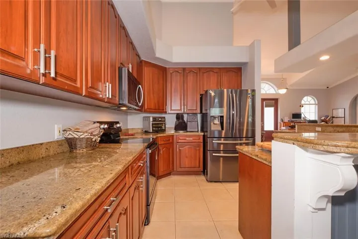 Beautiful granite counter tops with wood cabinetry.  Easy to entertain from this kitchen!