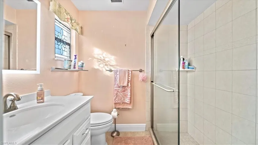 Bathroom featuring vanity and tiled shower