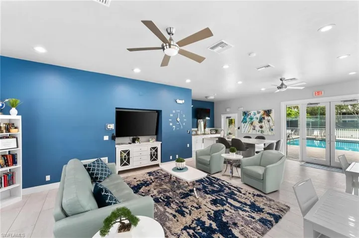 Living room with french doors, ceiling fan, and wood-type flooring